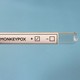 An empty vial marked "Monkeypox," with a + and - box.