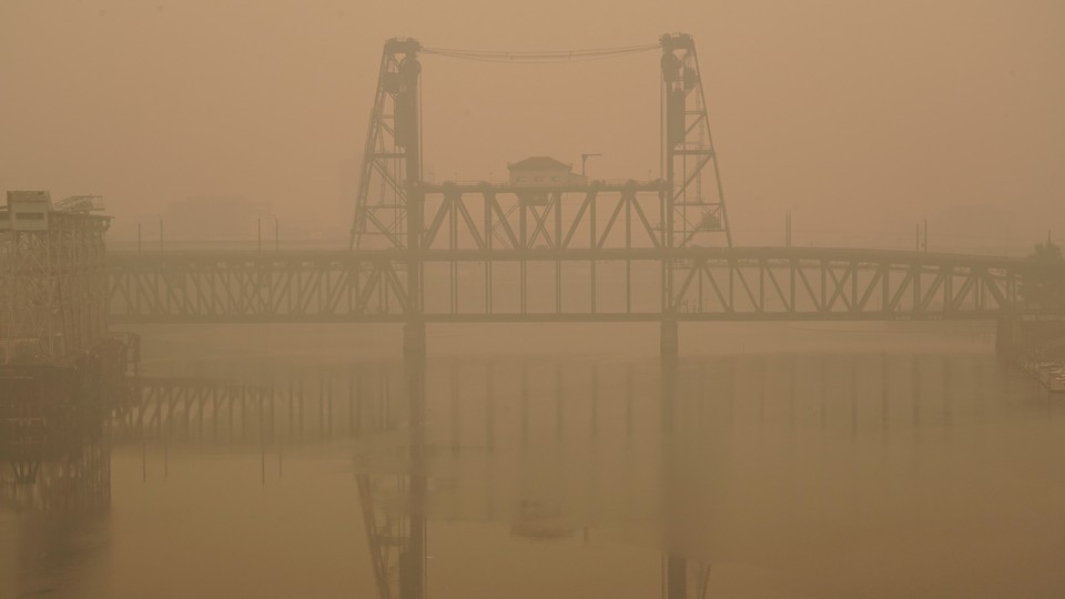 The Portland Steel Bridge covered in smoke from wildfires.