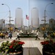 Pedestrians in New York are reflected in a window as they pass the World Trade Center site.