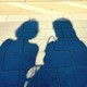 Shadows of two women waiting for the train
