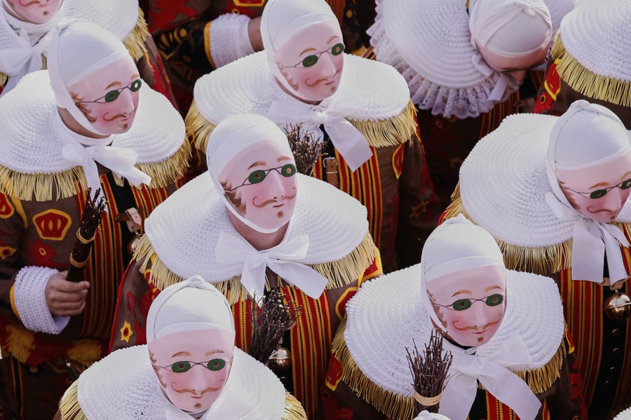 An elevated view of a group of masked performers in traditional costumes.