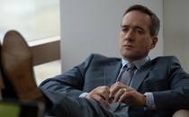 Tom Wambsgans from "Succession" sits in a chair, looking upset.