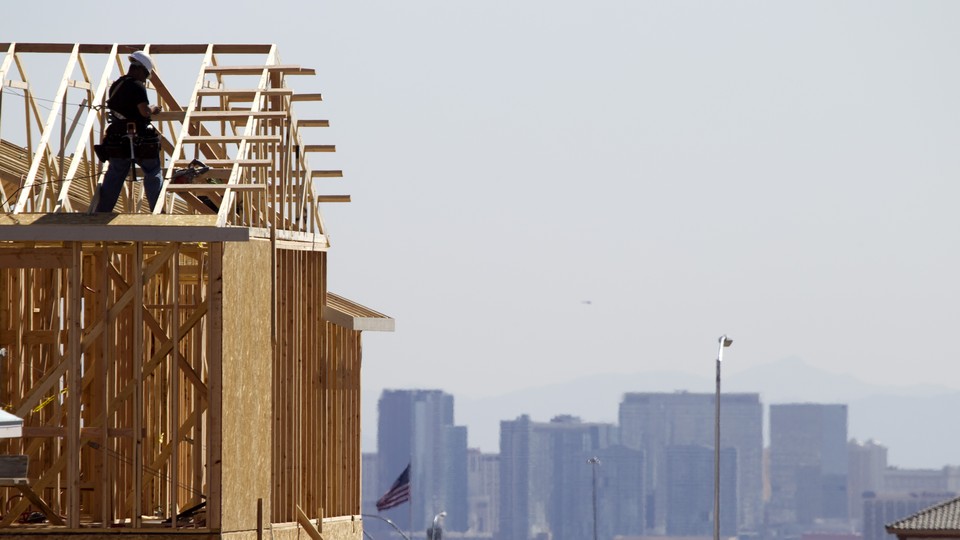 A carpenter works on a new home at a residential construction site on the west side of the Las Vegas Valley.