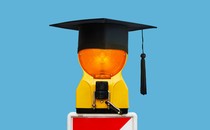A warning light with a graduation cap on top