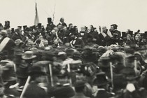 In a rare image of President Lincoln at Gettysburg, he is shown hatless at the center of a crowd on the orators’ platform.