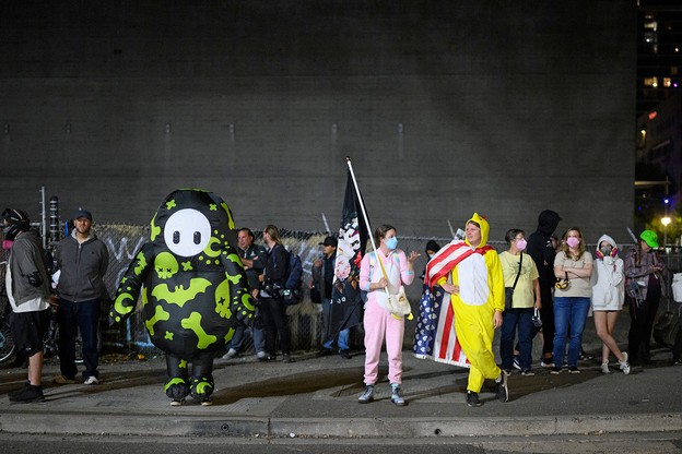 Portesters -- including one dressed in a chicken suit -- gather outside the ICE building in Portland.