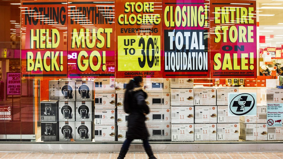 A retail store with signs advertising a pre-closing clearance sale