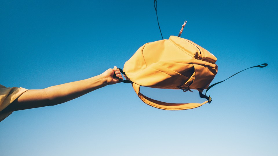 A yellow backpack swinging in the sky