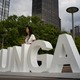 A woman stands at the grounds of the United Nations headquarters.