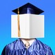 A graduate in cap and gown with a book covering their face