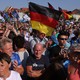 A photo of AfD supporters waving German flags at a rally ahead of the 2024 election.