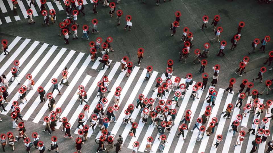 crosswalk covered in people walking with red circles around their heads