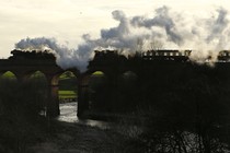 The Flying Scotsman steam engine passes over a viaduct in Bury, Britain, in 2016.