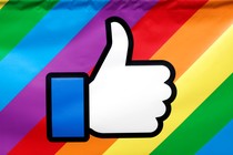 The Facebook thumbs-up logo is displayed on a rainbow-colored banner during the annual Pride parade in New York City, in 2016.