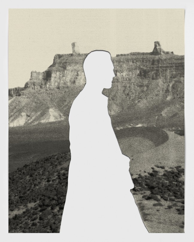 Silhouette of man against Libyan landscape