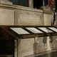 The original Constitution of the United States, in a museum display flanked by American flags