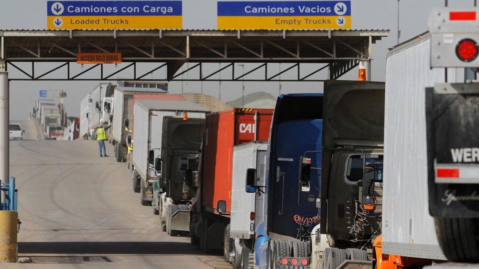 Trucks wait in a long queue for border customs control to cross into the U.S. at the Otay border crossing in Tijuana, Mexico.