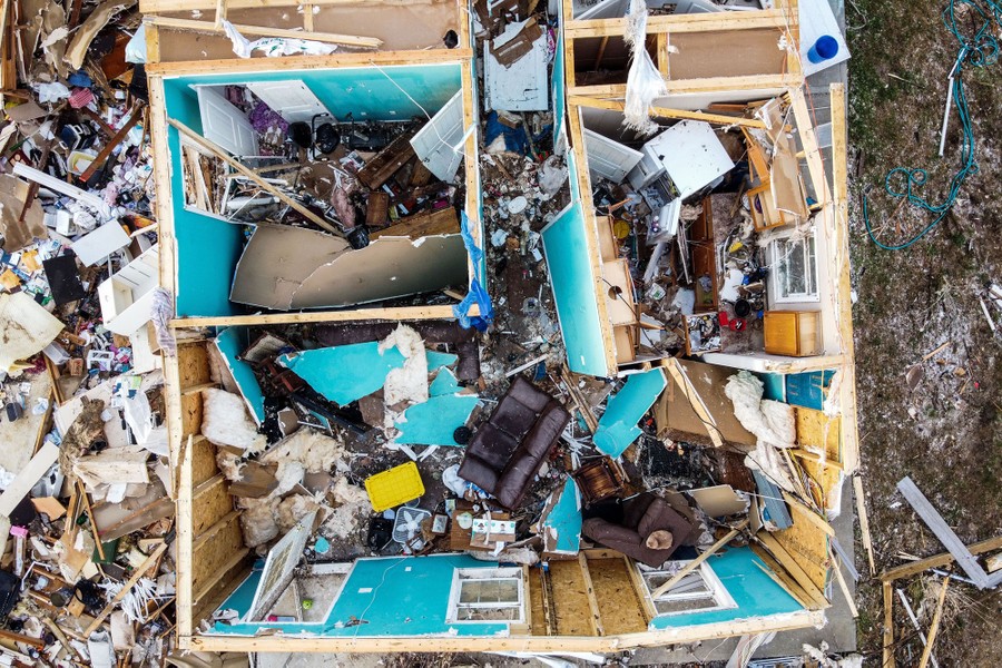 An aerial view of a tornado-destroyed house without a roof
