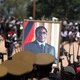 A portrait of Robert Mugabe is held up by Zimbabwean soldiers.