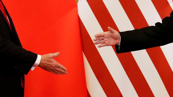 President Donald Trump and China's President Xi Jinping shake hands in Beijing.