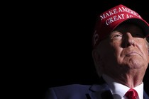 Photograph of Donald Trump with a MAGA hat on
