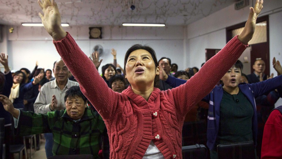A Chinese Christian woman sings during a prayer service at an underground Protestant church in Beijing.