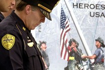 Tallahassee Police officer Kelly Burke bows his head to pray during a Sept. 11 rememberance ceremony at the Florida Capitol, Wednesday, Sept. 11, 2002.