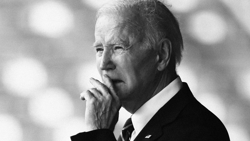 A picture of Joe Biden with his hand in front of his mouth