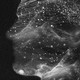 A silhouette of a person formed by waves and stardust