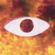 A digital and pixelated image of an eye with a raging fire behind it