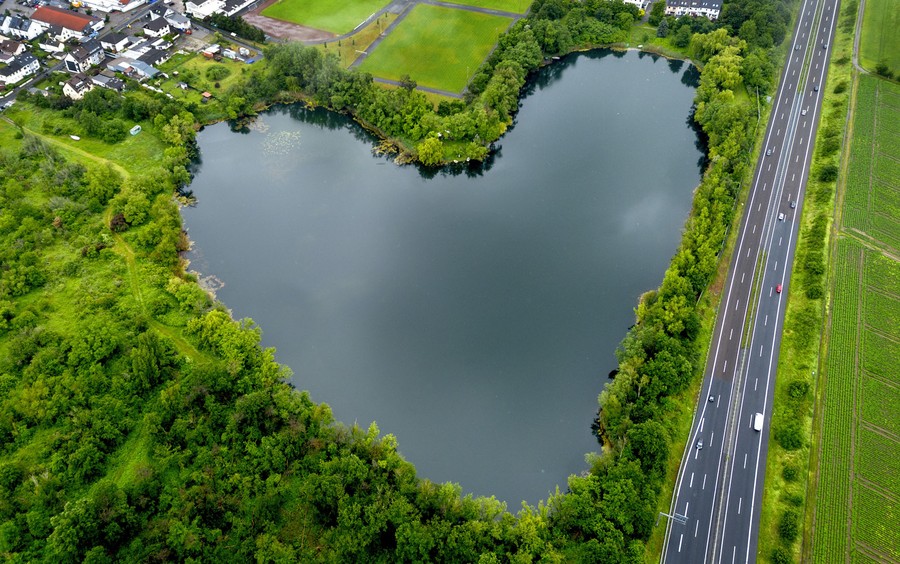 A heart-shaped lake surrounded by trees