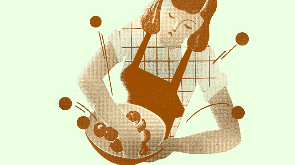 Woman in an apron cooking something in a bowl