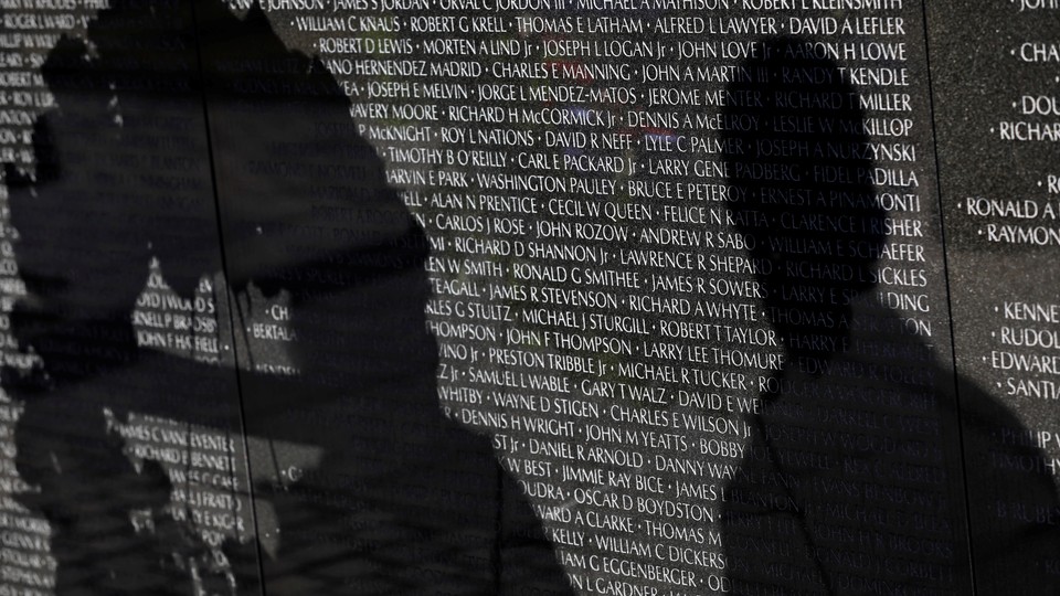 Visitors' shadows are seen cast on the Vietnam Veterans Memorial wall