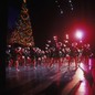 The Radio City Rockettes performing at Radio City Music Hall in front of a Christmas tree
