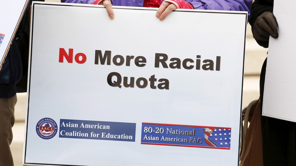 A sign says "No More Racial Quota"