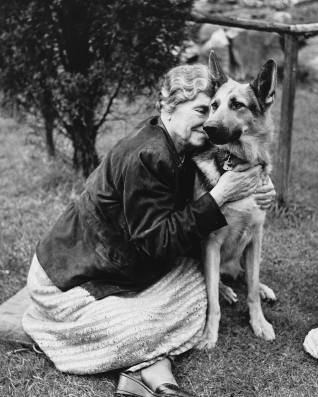 Helen Keller hugs her German Shepherd