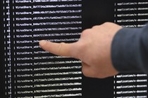 An IT researcher points at a computer infected by a ransomware.