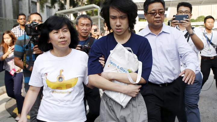 Teen blogger Amos Yee leaves with his parents after his sentencing from the State Court in Singapore July 6, 2015.
