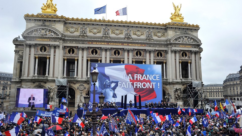 Marine Le Pen delivers a speech on stage during the National Front annual rally honoring Joan of Arc on Place de l'Opera, on May 1, 2015 in Paris, France.