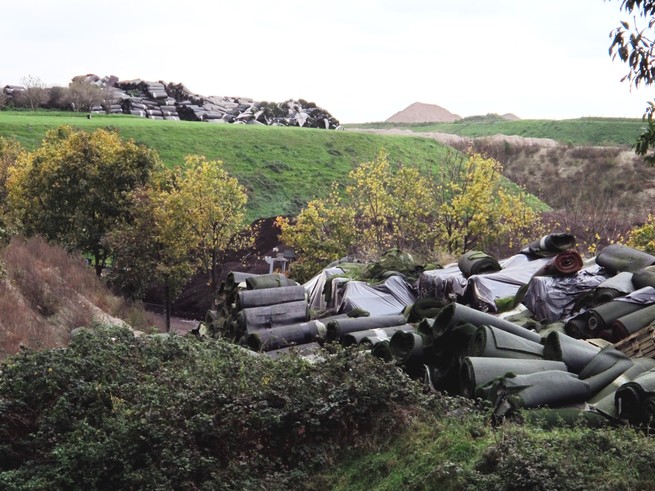 Two piles of used artificial turf were stockpiled in the Netherlands countryside