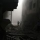 Residents inspect damage from what activists said was an air strike by forces loyal to Syrian President Bashar al-Assad on the town of Douma in Damascus, Syria, on October 2, 2015.