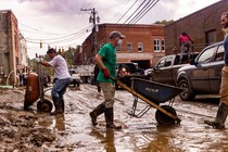 Residents and volunteers clean up on Tuesday, Oct. 1, 2024, after the French Broad River flooded downtown Marshall, North Carolina. The remnants of Hurricane Helene caused widespread flooding, downed trees, and power outages in western North Carolina.