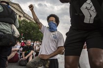 A demonstrator in D.C. raises a fist while protesting against police brutality and racism. This is the 12th day of protests with thousands of people descending on the city to peacefully demonstrate in the wake of the death of George Floyd, an African-American man who was killed in police custody in Minneapolis on May 25. (Photo by Probal Rashid / LightRocket via Getty)