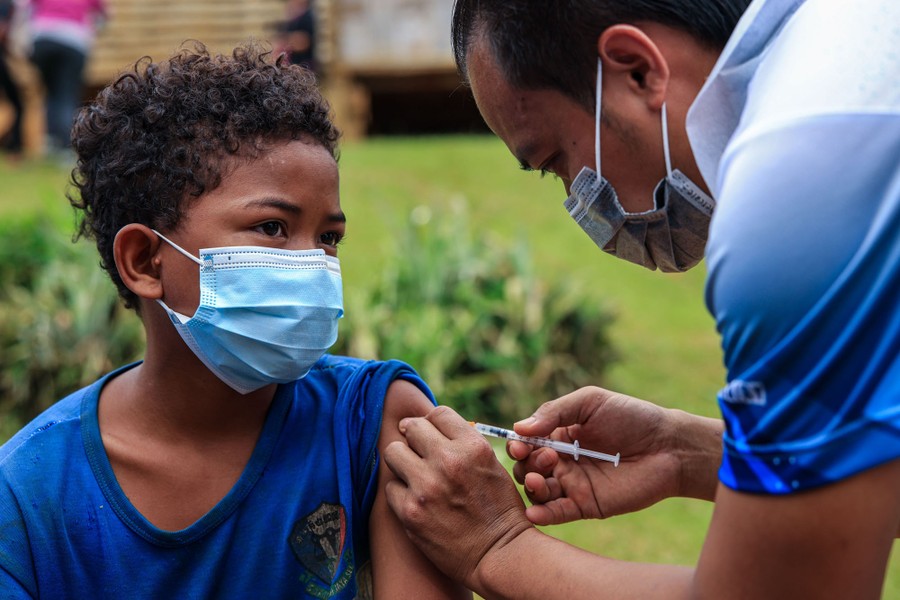 A young person is given a vaccine shot.