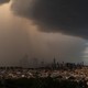 Dark rain clouds hover over the New York City skyline.