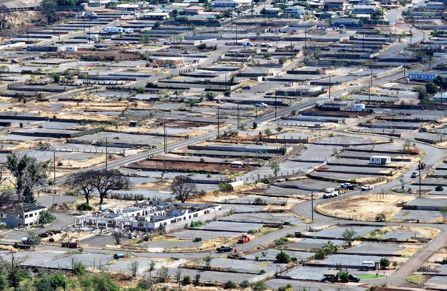 An aerial view of a residential neighborhood with many empty lots, the fire-destroyed ruins of houses having been removed.