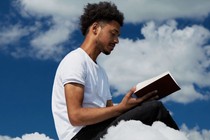 An AI-generated image of a man reading a book