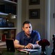 Nizar Zaka sits at a desk, facing past the camera.
