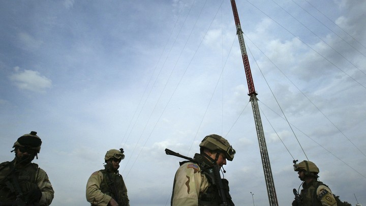 U.S. forces stand in front of Mosul TV-station transmitters.