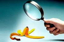 Illustration showing a hand holding a magnifying glass pointed at a banana peel on the floor (the kind that could cause someone to slip)